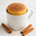 Churro mug cake recipe with cinnamon sugar topping in white ceramic mug