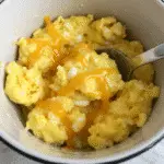 Egg and cheese mug scramble served in terracotta ceramic mug with fluffy texture