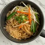 Pad Thai in a mug with rice noodles and colorful vegetables