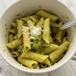 Creamy pesto pasta in white ceramic mug with parmesan cheese - BusyCookLife 5-minute microwave recipe
