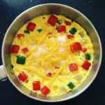 Fluffy veggie omelet mug cup with colorful bell peppers and cheese - quick 2-minute microwave breakfast recipe from BusyCookLife