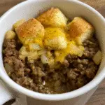 Delicious cheeseburger in a mug with melted cheddar cheese and seasoned ground beef, perfect quick microwave meal